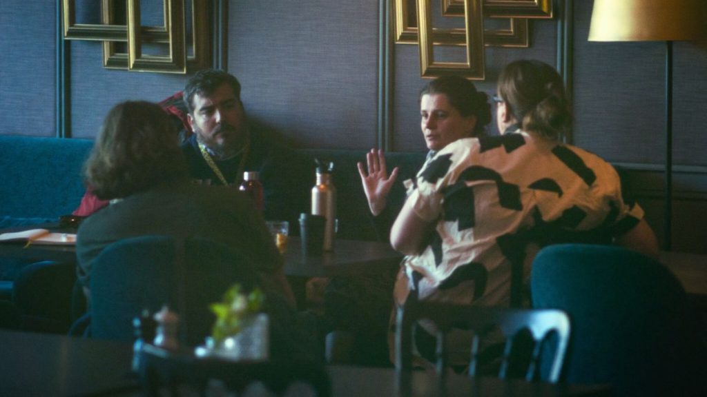3 women and 1 man having a meeting at a restaurant