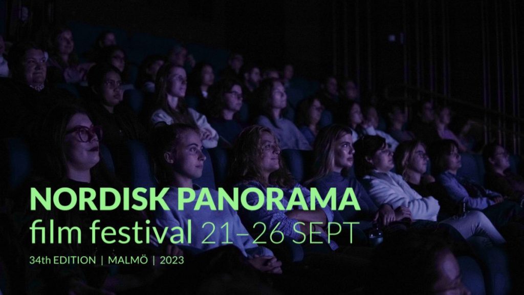 Women sitting in a dark cinema watching a film